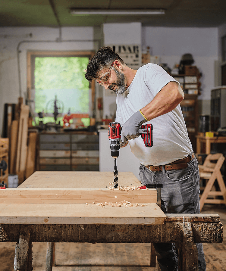 Picture of a man working in a workshop with a cordless screwdriver