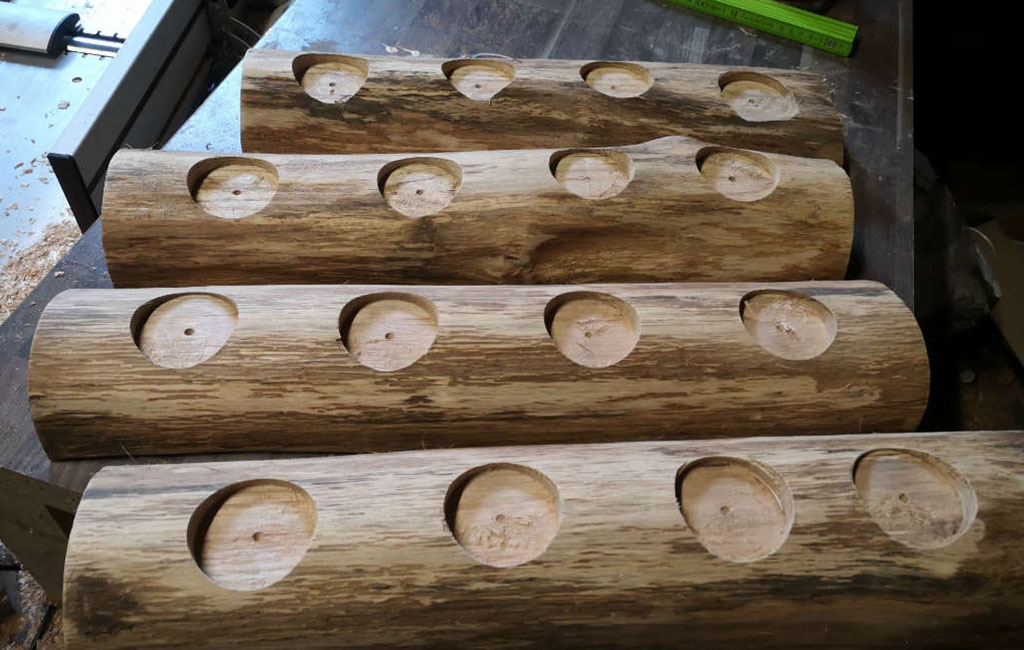 Wooden logs with drilled holes prepared for tealight holders