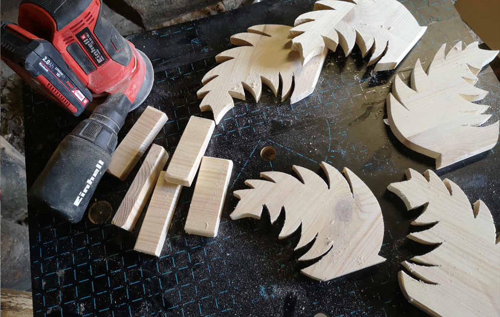 Wooden decorative pieces and small blocks prepared for a DIY Christmas decoration