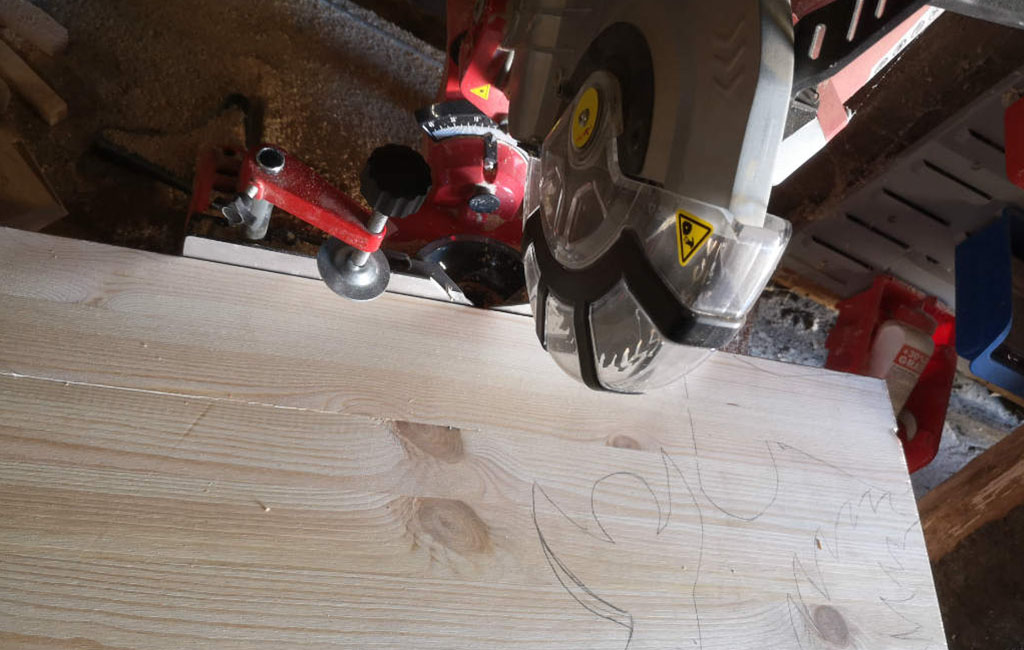 Cutting a wooden board with a circular saw for a DIY decoration