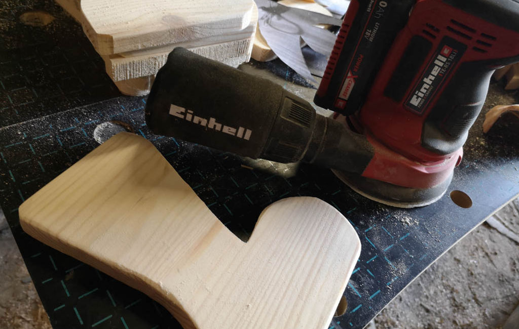 Sanding a wooden surface with a power sander