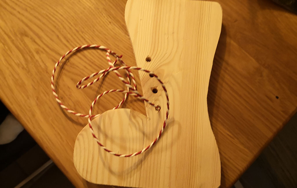 Decorative red-and-white twine placed on a wooden surface