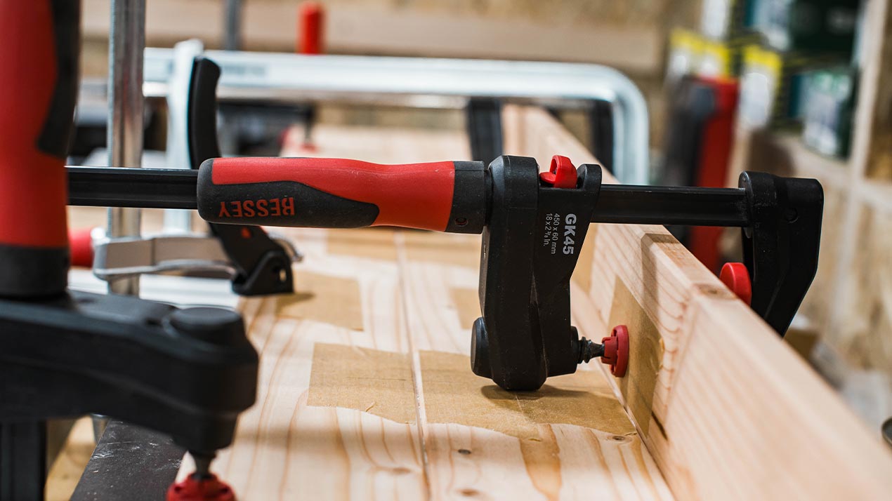 Wooden boards held together with a screw clamp.