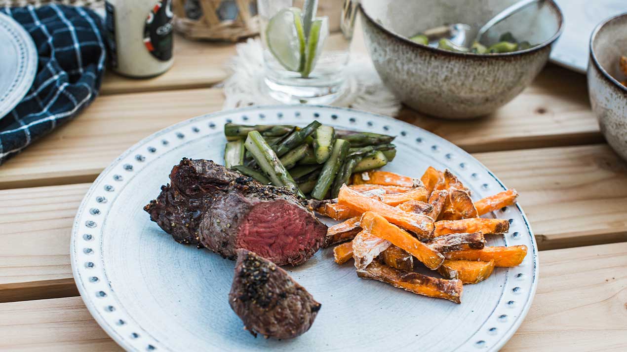 plate with meat vegetables and fries