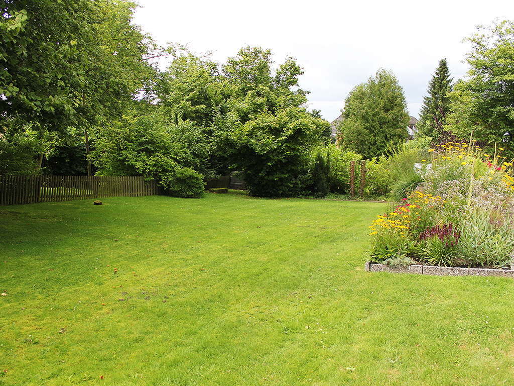 mown lawn with flower bed