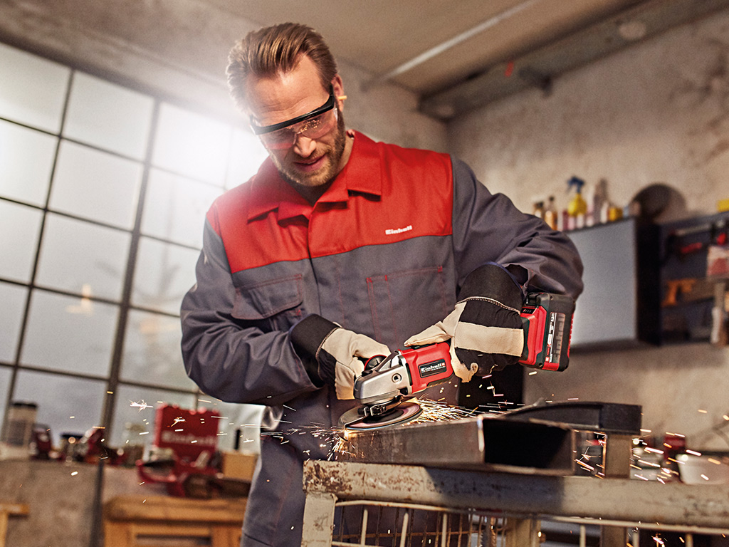 a man cuts with an angle grinder and sparks fly