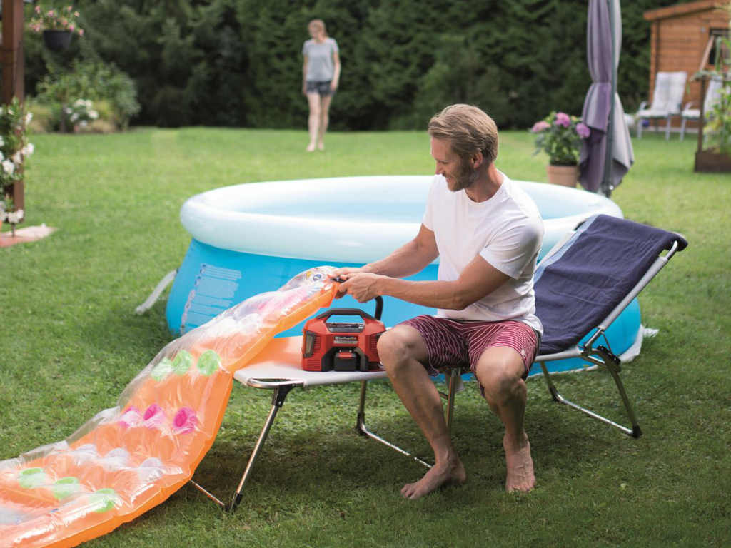 a man inflates a water air mattress with the compressor