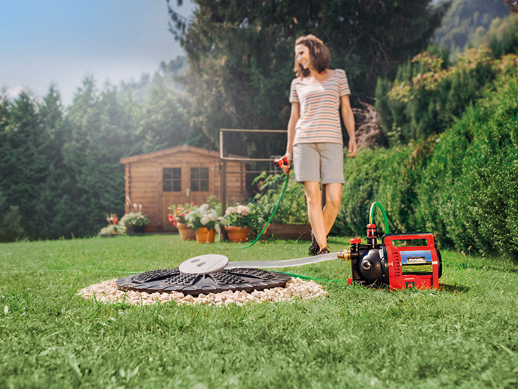 a woman with a water hose in her hand