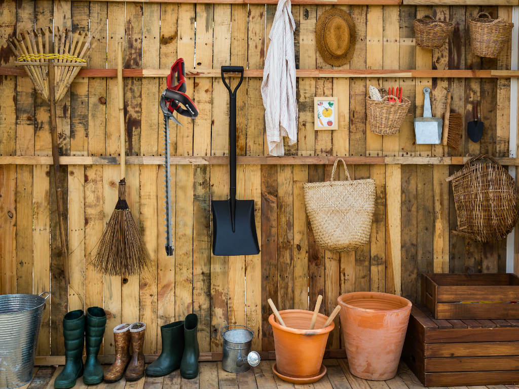 Garden tools and garden equipment hang on the wall