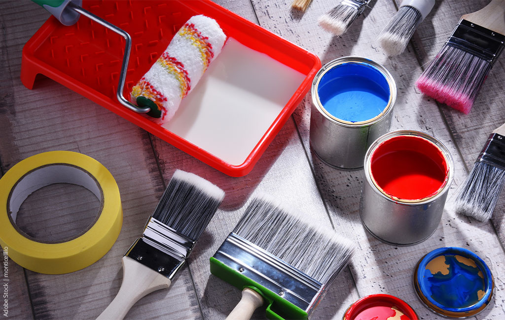 Various painting utensils: brushes, tape, paint, paint roller