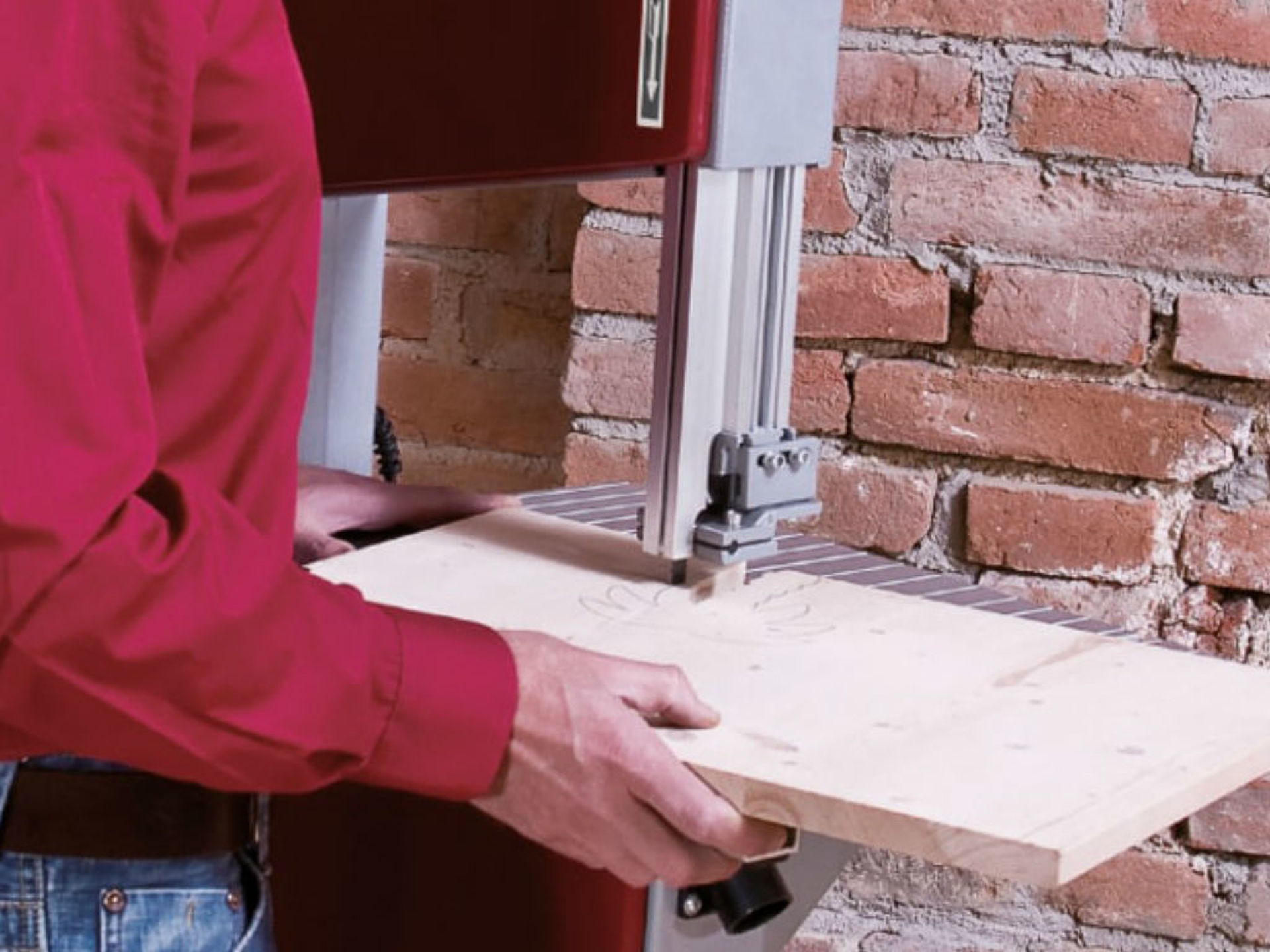 A piece of wood is cut with a jigsaw