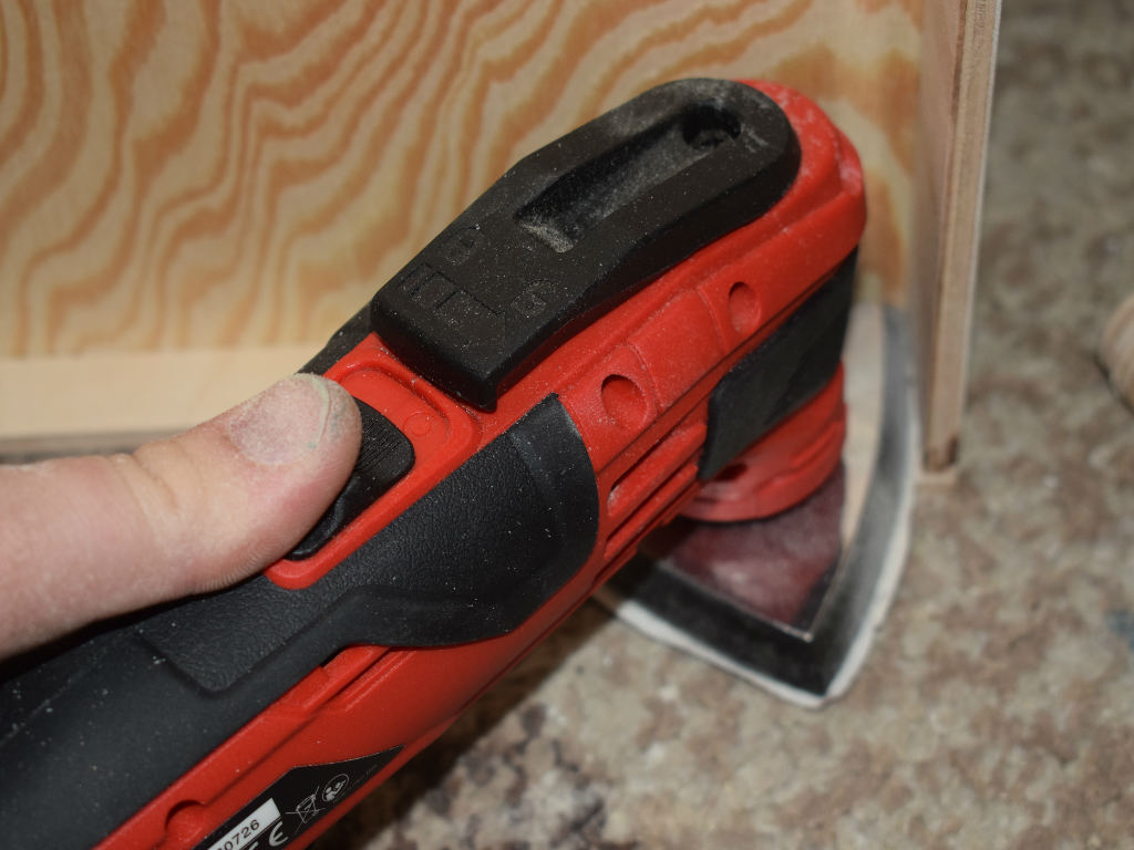 wood is sanded with a triangular sander