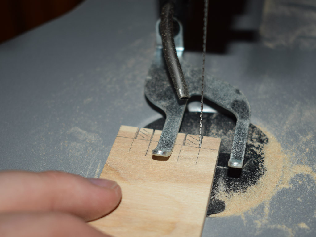 wood particles are cut out with jigsaw