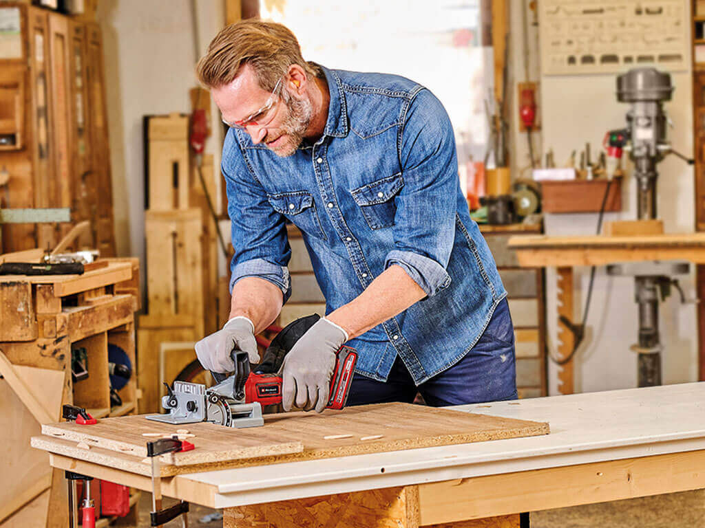 a man used biscuit jointer in wood