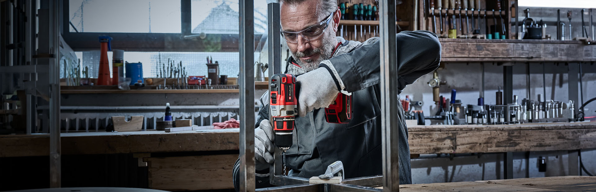 Craftsman drilling a hole into a metal profile with an Einhell drill.