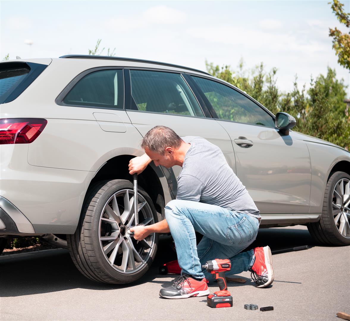 a man changes his car tire