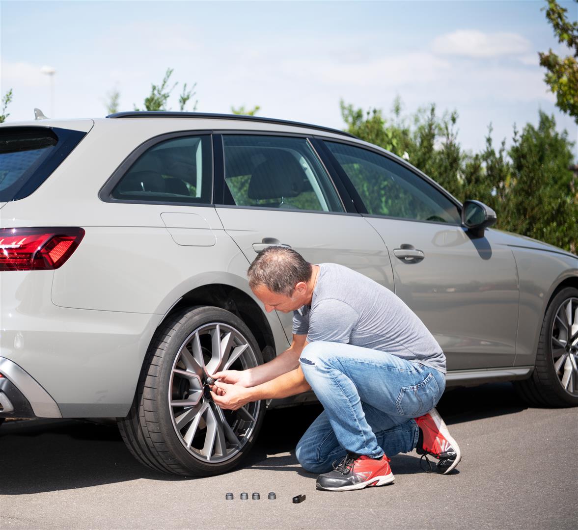 a man loosens the screws of his car