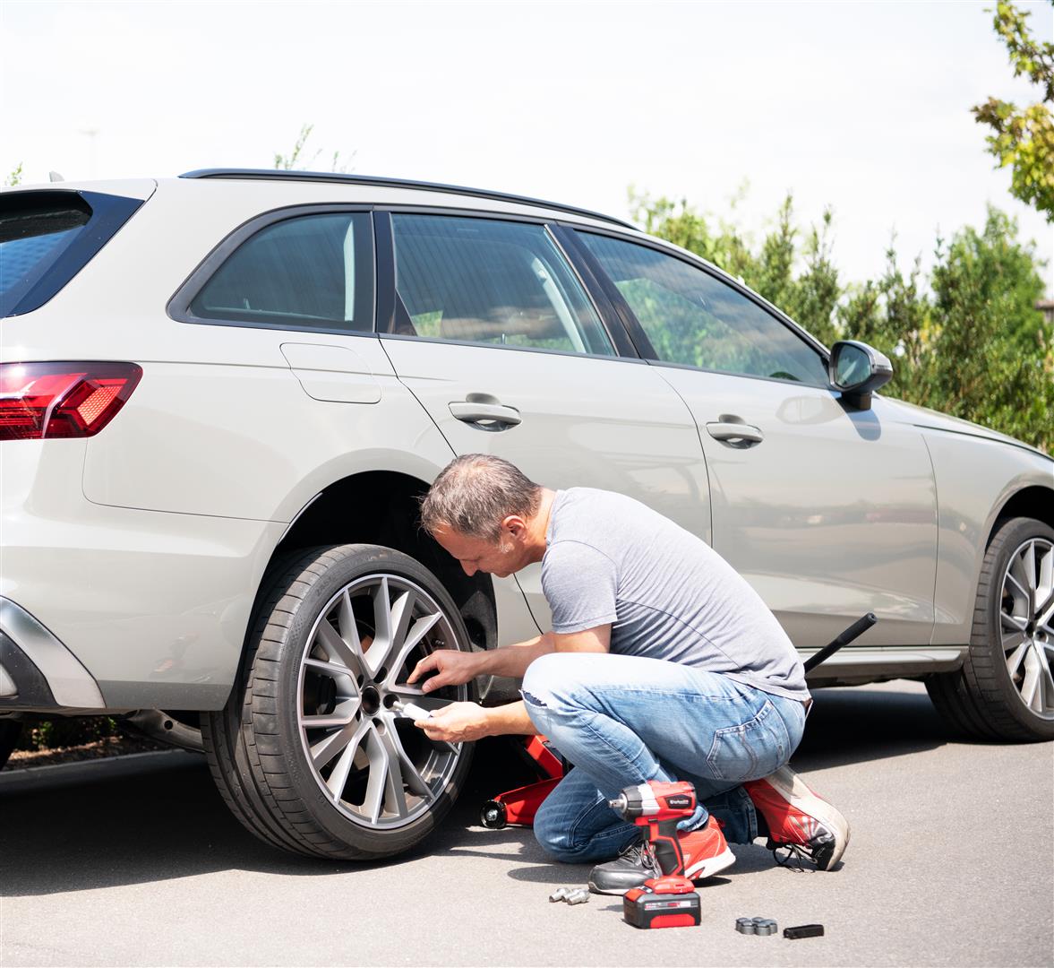 a man changes his car tires