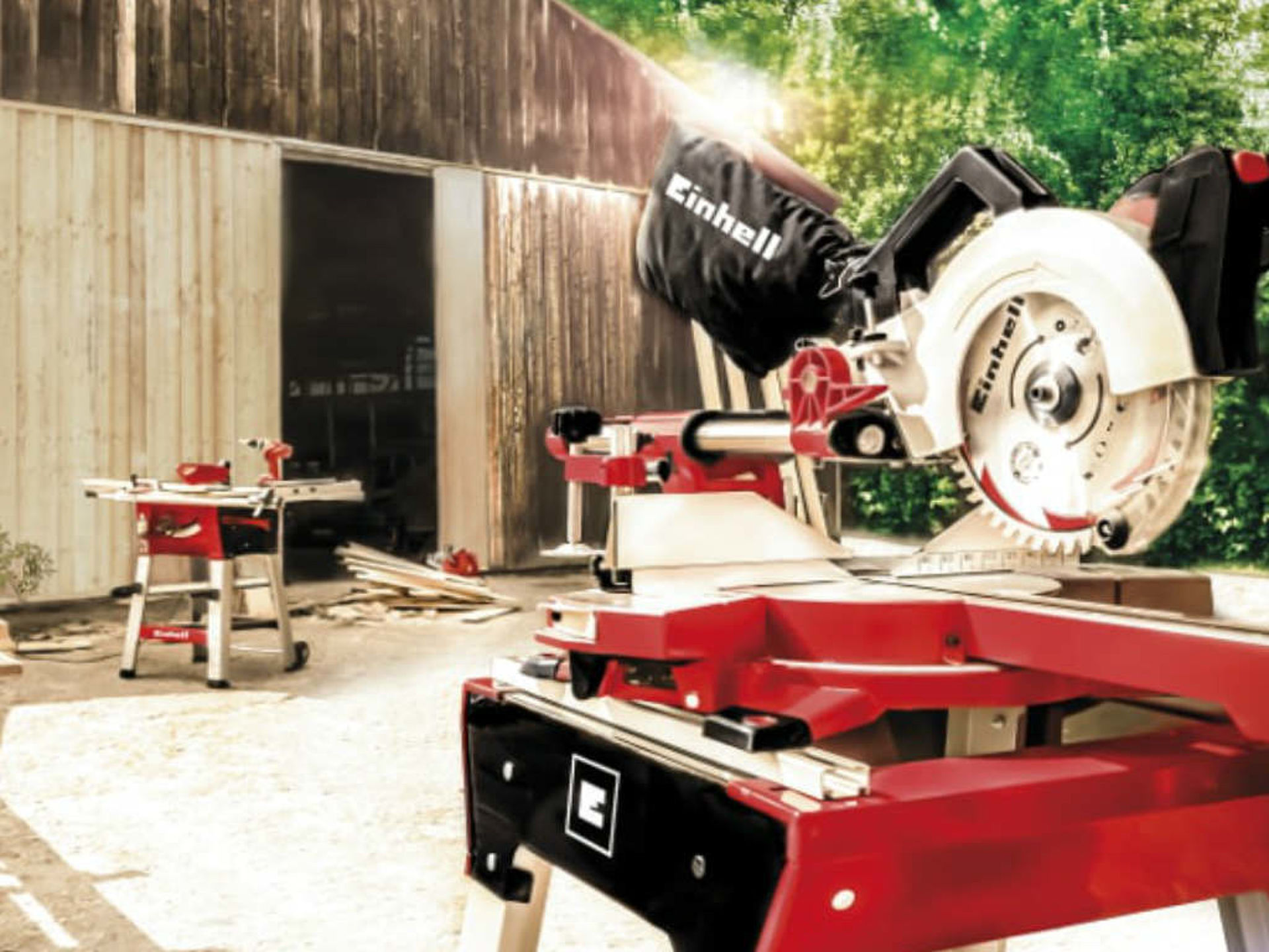 hand circular saw stands in front of a wooden hut