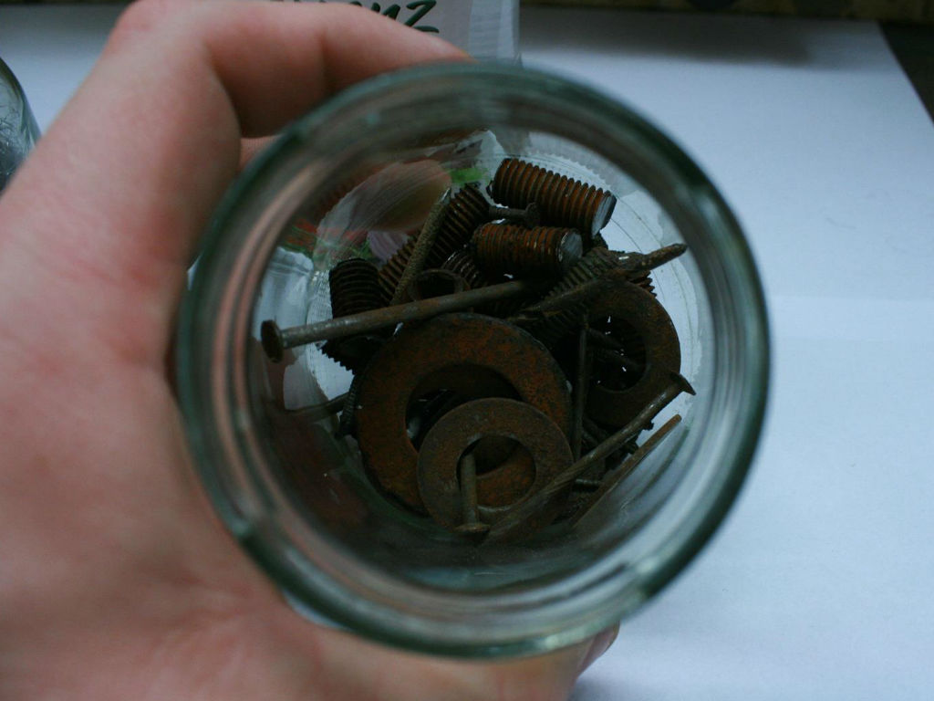 rusty nails and screws in a jar