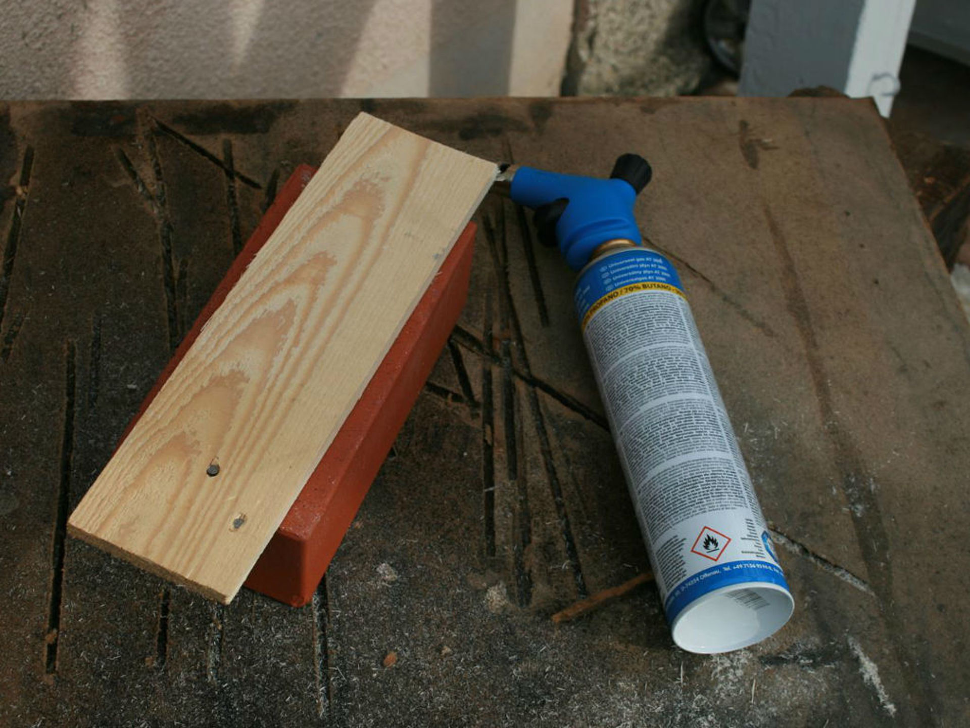 wooden board lies to the left of a can