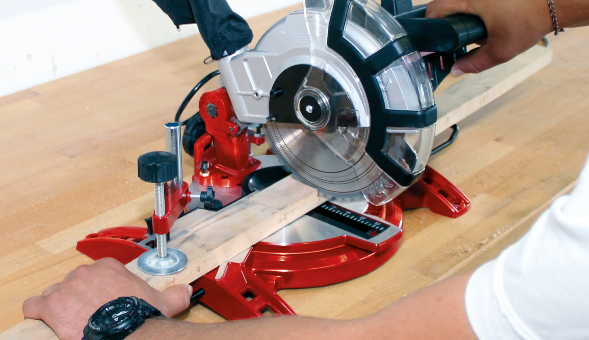 Close-up of a red mitre saw cutting wood
