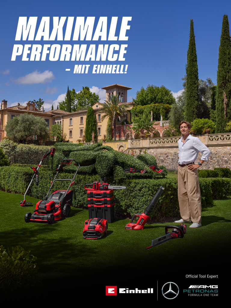 George Russell mit Einhell-Geräten vor einer Rennwagen-Hecke, Text: „Maximale Performance – mit Einhell!“