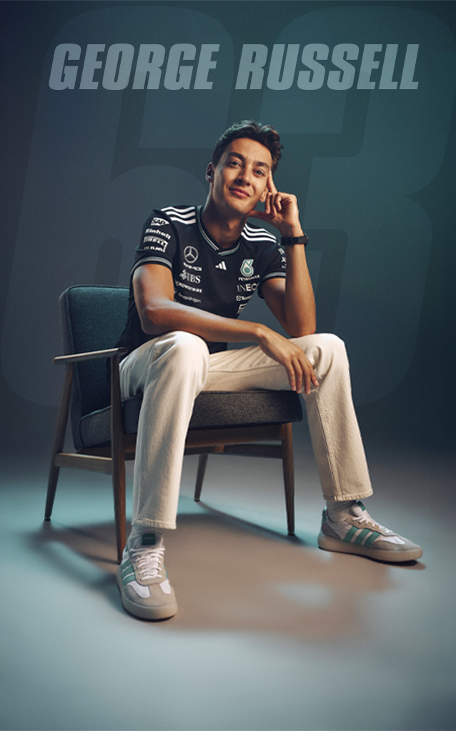 Formula 1 driver George Russell sits relaxed in a chair, with his name displayed in large text behind him against a dark background.