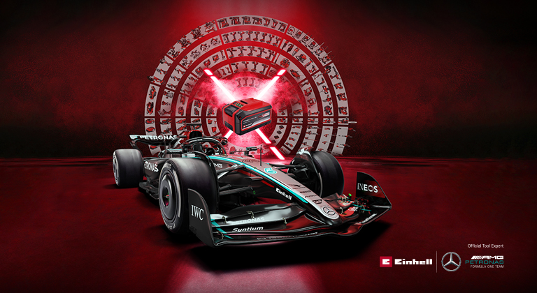 A Mercedes-AMG PETRONAS Formula 1 car is set against a vibrant red background featuring an Einhell battery at the center. The Einhell and Mercedes-AMG PETRONAS F1 Team logos are displayed in the bottom right corner.