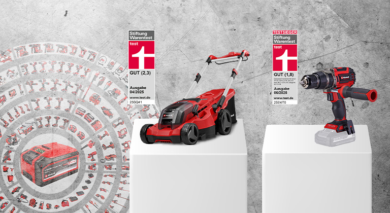 Zwei Einhell-Produkte auf weißen Sockeln vor grauem Hintergrund: links der Einhell Professional Akku-Rasenmäher GP-CM 36/450 mit dem Stiftung Warentest-Urteil GUT (2,3), Ausgabe 04/2025. Rechts daneben der Einhell Professional Akku-Schlagbohrschrauber TP-CD 18/70 Li-i BL - Solo mit dem Testurteil GUT (1,8), Ausgabe 06/2025. Im Hintergrund sind viele weitere Einhell-Geräte kreisförmig angeordnet.