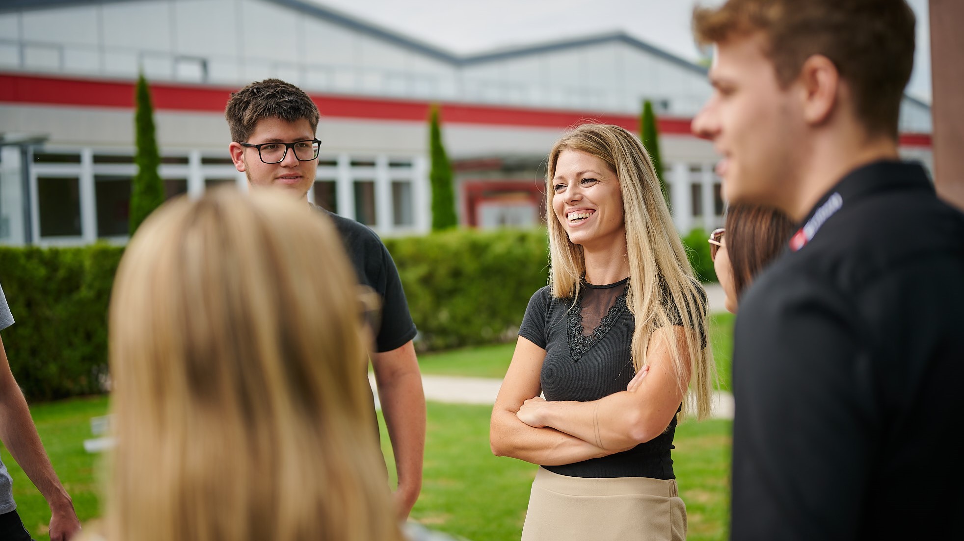 A group of people talking and smiling at each other.