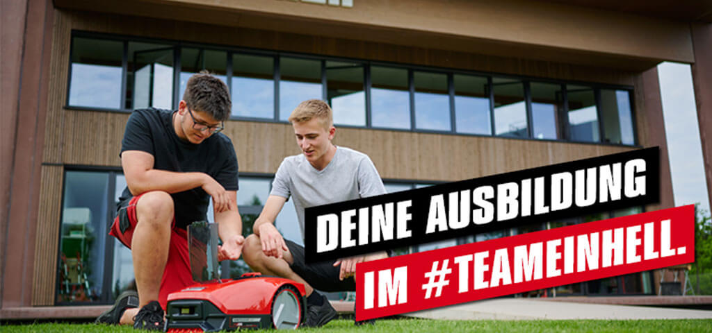 Advertising image of two men setting up the robotic lawn mower. 