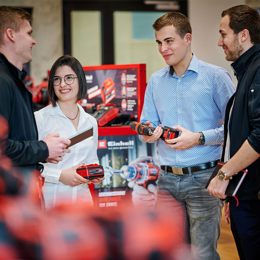 four Einhell employees with einhell devices in their hands
