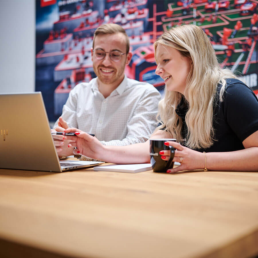 A man and a woman looking into the laptop. 