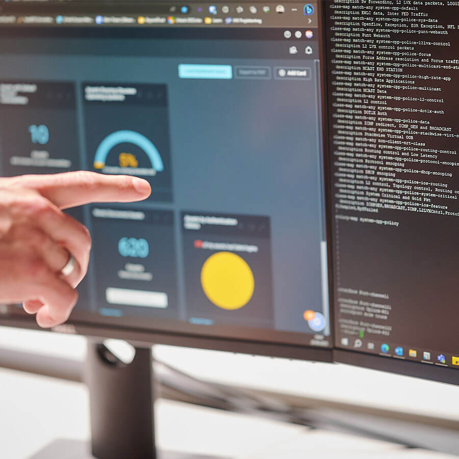 A finger pointing at the computer.