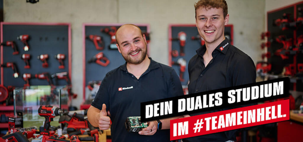 Advertising image of two men smiling into the camera while standing in the workshop. 