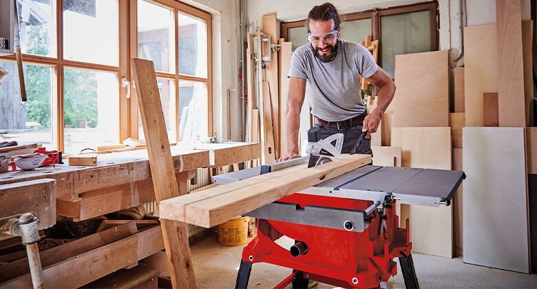 man using an electric table saw