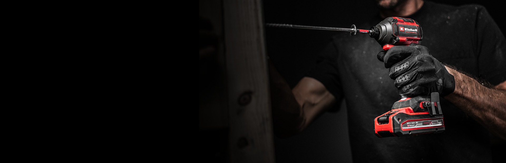 The banner shows a man tightening a screw with an Einhell cordless impact driver. The background is dark, with the focus on the tool.