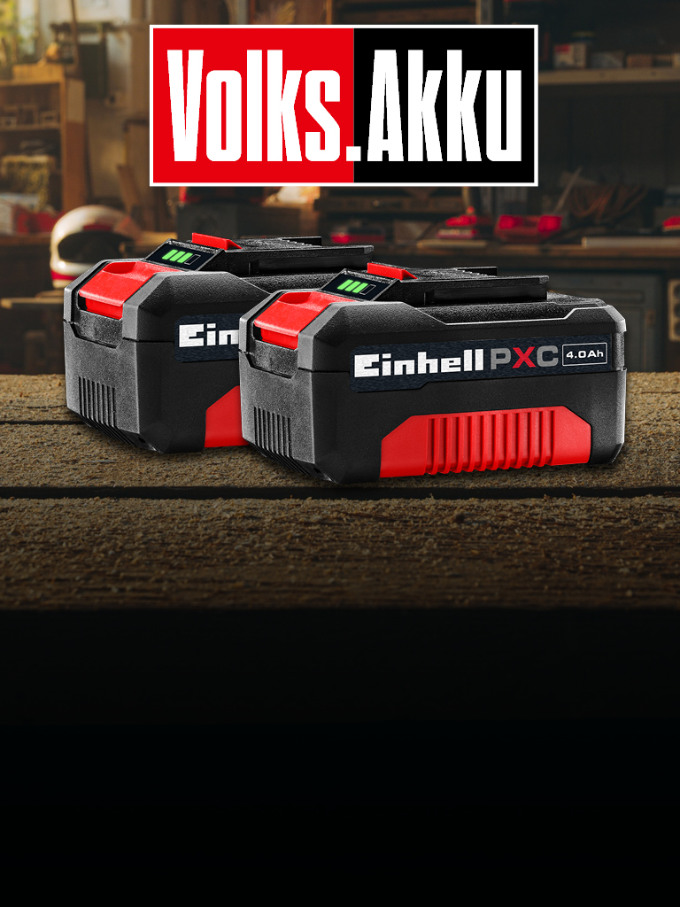 In the background, a workshop is visible. In the foreground, there are two Einhell 4.0 Ah PXC batteries. The text “Volks.Akku” appears in the image.